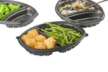 meat nuggets and asparagus in disposable dishes isolated on white background