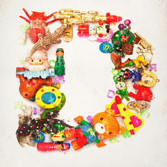 the letter D made up of small toys and Chrismas