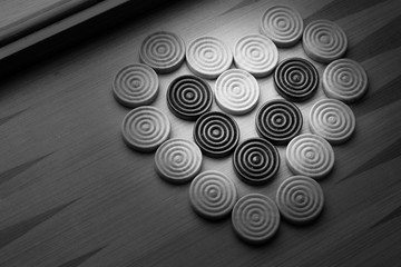 heart shaped checkers on a game board black and white 