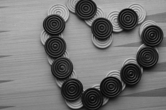 heart from chekers on wooden background black and white color 