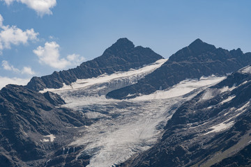 snow-covered mountain with a glacier, a rocky peak in the afternoon. Caucasus, Russia