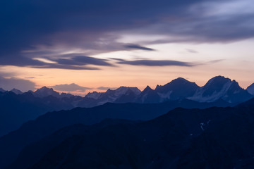 Dawn in the mountains. Old high, sharp mountain peaks on the background of the dawn. The Caucasus.