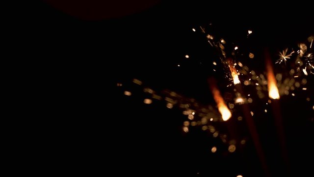 Burning sparklers on black background. Super Slow Motion. Filmed on high speed cinema camera, 1000fps.