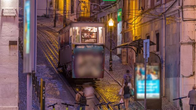 Lisbon's Gloria funicular day to night transition timelapse located on the west side of the Avenida da Liberdade connects downtown with Bairro Alto. It's classified as a national monument opened 1885