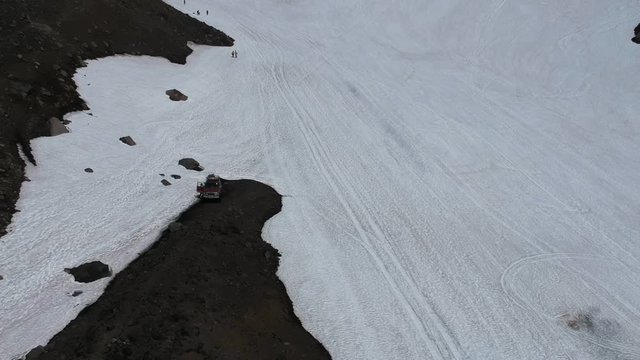 Russia, Kamchatka, snow-covered path to the Avachinsky volcano. Dangerous adventure. Extreme journey. Aerial shot. 