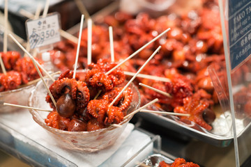 Tako tamago at Nishiki Market in Kyoto. Tako tamago is a popular street food snack, it is a baby octopus with a boiled quail egg stuffed into its head.