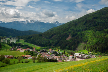 Fototapeta na wymiar A glorious Alpine landscape overlooking a small village in Tyrol