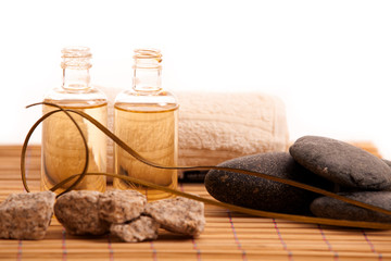 Small bottles with aroma oils ans spa face towels