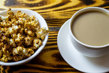 popcorn cornflakes with a cup of coffee, top view, selective focus