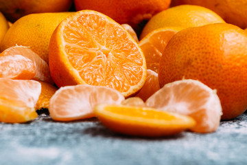 Ripe cut tangerine closeup on gray table