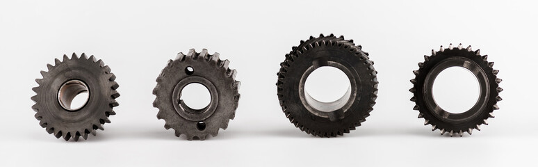 metal round gears in row on white background, panoramic shot