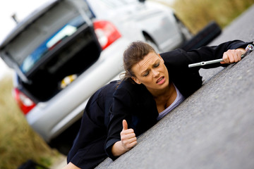 Fototapeta na wymiar Woman in despair her broken down car