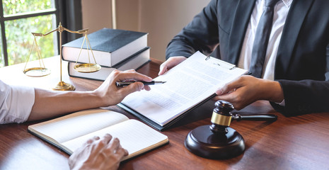 Male lawyer discussing negotiation legal case with client meeting with document contact in...