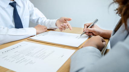 Car rental and Insurance concept, Young salesman presenting and pointing signature form to customer signing after decision sign agreement contract with approved good deal for rent or purchase