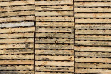 Wall of stacked wooden pallets texture background pattern