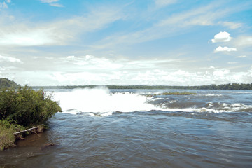 View of Devil`s Throat Against Blue Sky and At Iguazu Falls, Argentina