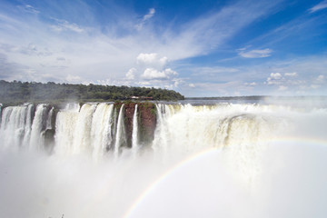 View of Devil`s Throat With Rainbow Against Blue Sky and At Iguazu Falls, Argentina
