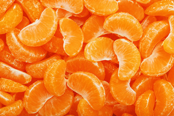 Lots of slices of juicy tangerines as background texture.