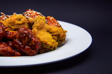 Fried chicken wings on black background