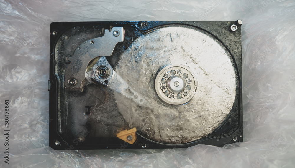 Poster close up beautiful open detail frozen hard disk on a table background. concept protection informatio