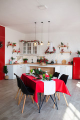 Modern Kitchen Interior with Island, Sink, Cabinets in New Luxury Home Decorated in Christmas Style.