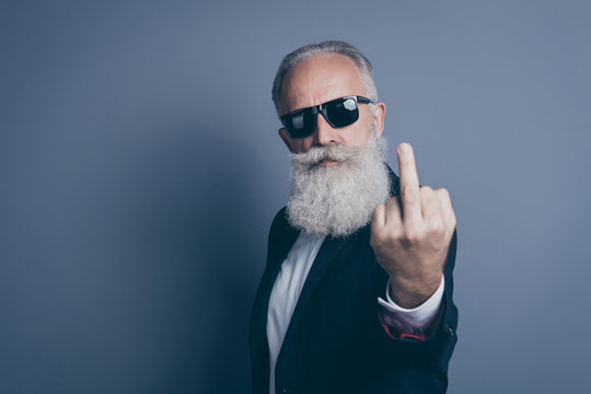Close-up portrait of his he nice attractive chic classy brutal serious mean gray-haired man demonstrating offensive behavior showing middle finger isolated over dark grey pastel color background
