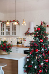 Modern Kitchen Interior with Island, Sink, Cabinets in New Luxury Home Decorated in Christmas Style.