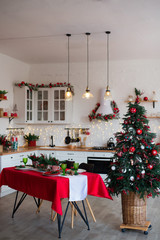 Modern Kitchen Interior with Island, Sink, Cabinets in New Luxury Home Decorated in Christmas Style.