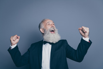 Close-up portrait of his he nice attractive cheerful cheery satisfied overjoyed gray-haired man celebrating accomplishment breakthrough win isolated over dark grey pastel color background