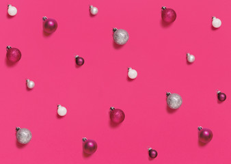 Christmas baubles on a pink background