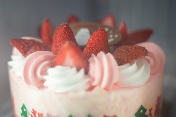 Fresh strawberry topping over whipping cream on cake