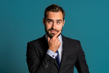 Positive thinking businessman looking up and around on blue background. Happy face expressions. Handsome male model in campaign suit.