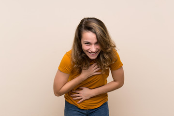 Young blonde girl over isolated background smiling a lot