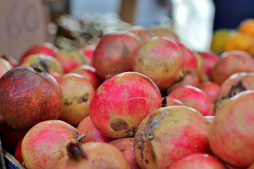 Bunch of ripe pomegranates at an outdoor market stall