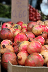 Bunch of ripe pomegranates at an outdoor market stall