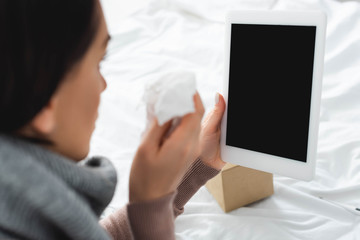sick woman with napkin having online consultation with doctor on digital tablet