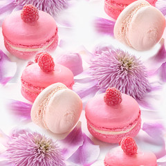 Macaroni with raspberries, marshmallows on a background of beautiful flowers of clematis. Close-up.