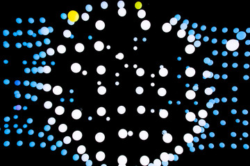 Abstract glowing balls in the air. Many balls of different shapes on a black background