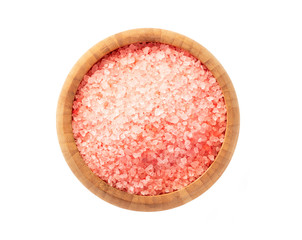 Pink aromatic bath salt in a wooden bowl isolated on a white background, top view.