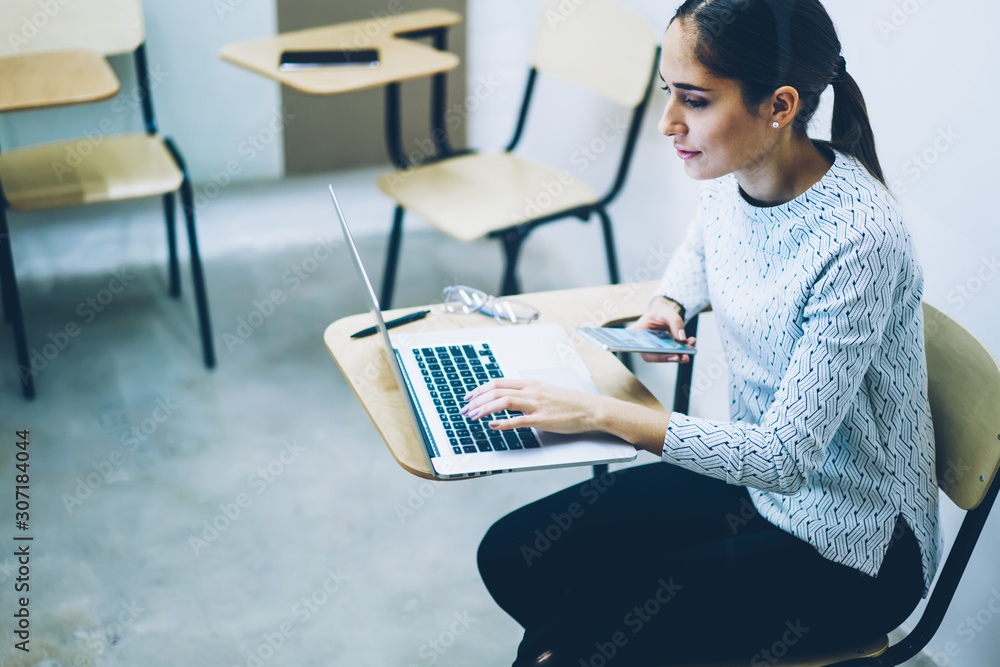 Aufkleber pensive female student using laptop computer for learning sitting in college classroom, young woman 