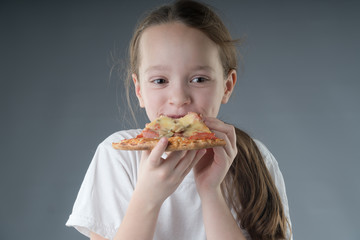  the child is eating pizza.