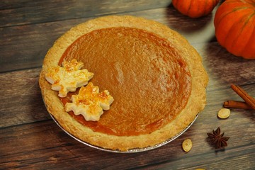 Pumpkin pie with maple leaves cut out pastry, top view