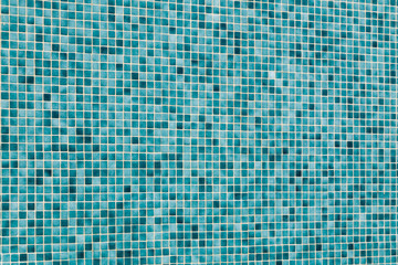 light turquoise blue mosaic tiles on a wall in angle view