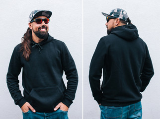 City portrait of handsome hipster man with beard wearing black blank hoodie or sweatshirt with...