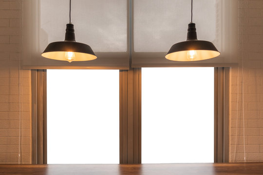 Ceiling lamp shining to Empty wooden table top with white color window. background interior concept.