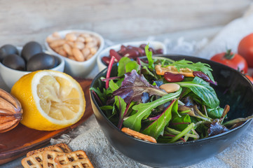 Delicious and healthy salad with beans, arugula, tomatoes and lemon juice. Healthy fitness food for dieters and vegans