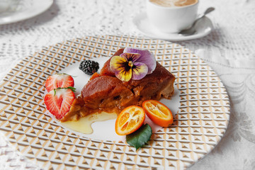 Apple dessert with cinnamon on a plate on the table in a restaurant. Close-up, copy space