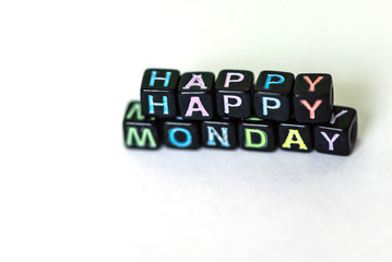 Obraz premium Happy Monday of blocks on white page open notebook on desktop