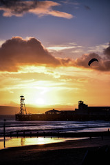 Kite flying on a beach at sunset