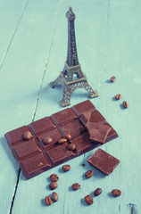  Eiffel, chocolate and coffee beans on wooden table